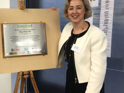 Chair Emma West with building plaque